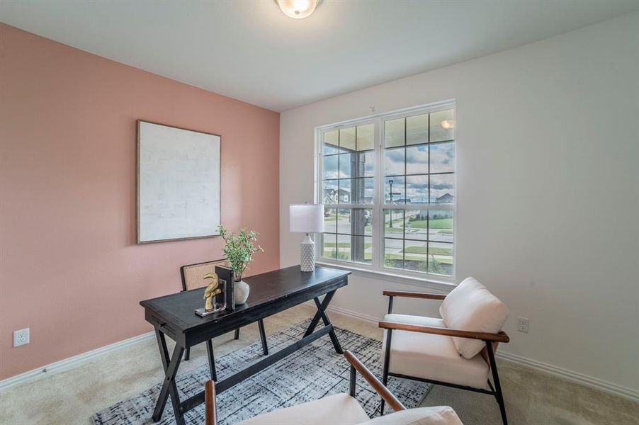 Office area with light colored carpet and baseboards Office area with light colored carpet and baseboards