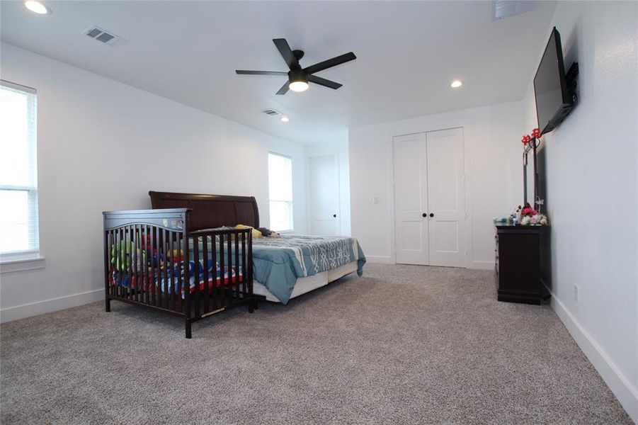 Bedroom featuring light colored carpet, a ceiling fan, and recessed lighting Bedroom featuring light colored carpet, a ceiling fan, and recessed lighting