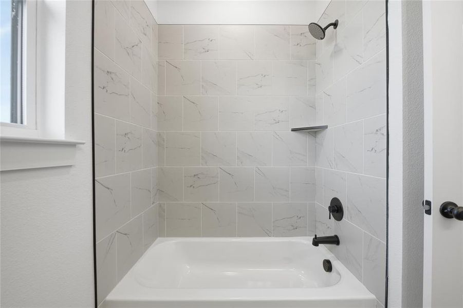 Bathroom featuring shower / bath combination Bathroom featuring shower / bath combination