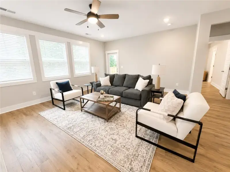 Natural light floods this inviting living space, c