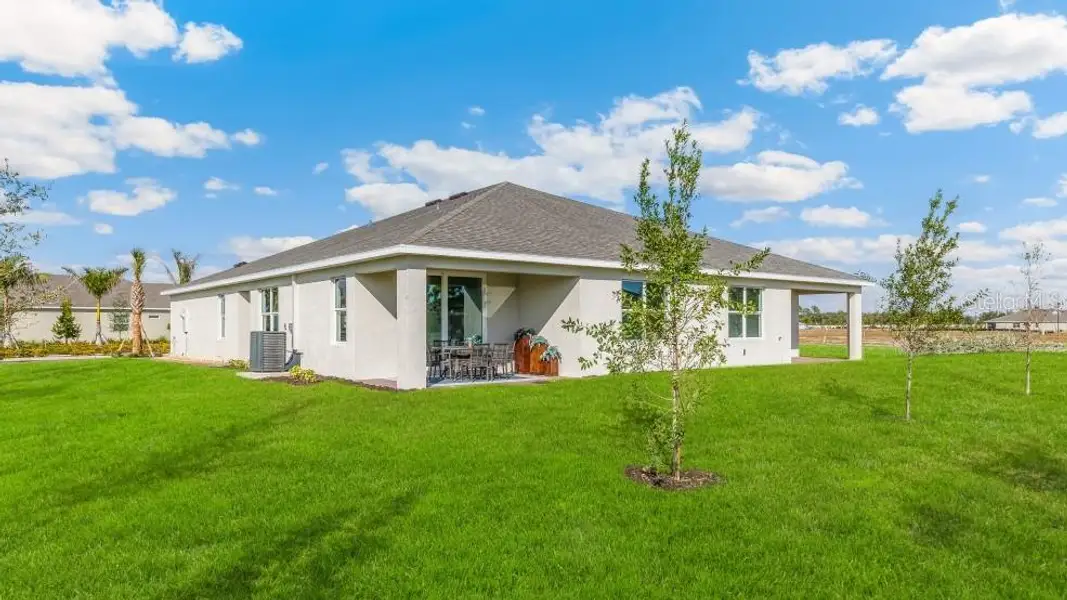 Exterior details and patio area of a home in Cove at West Port - Express, Port Charlotte (Image 3).