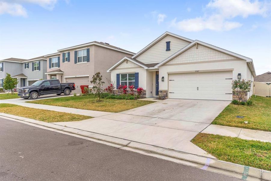 Front exterior of a new home in Farm at Varrea, Plant City, FL, highlighting curb appeal (Image 26). Front exterior of a new home in Farm at Varrea, Plant City, FL, highlighting curb appeal (Image 26).