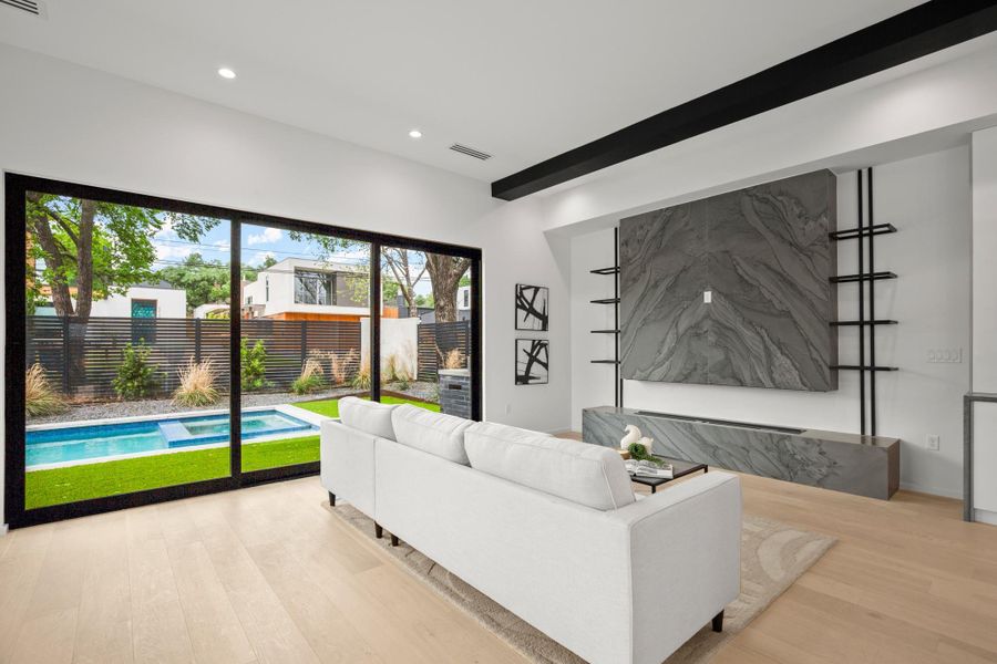 Living area featuring light wood-style flooring and recessed lighting