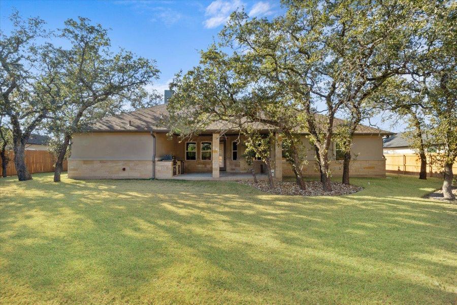 Rear view of house with a patio and stucco siding Rear view of house with a patio and stucco siding