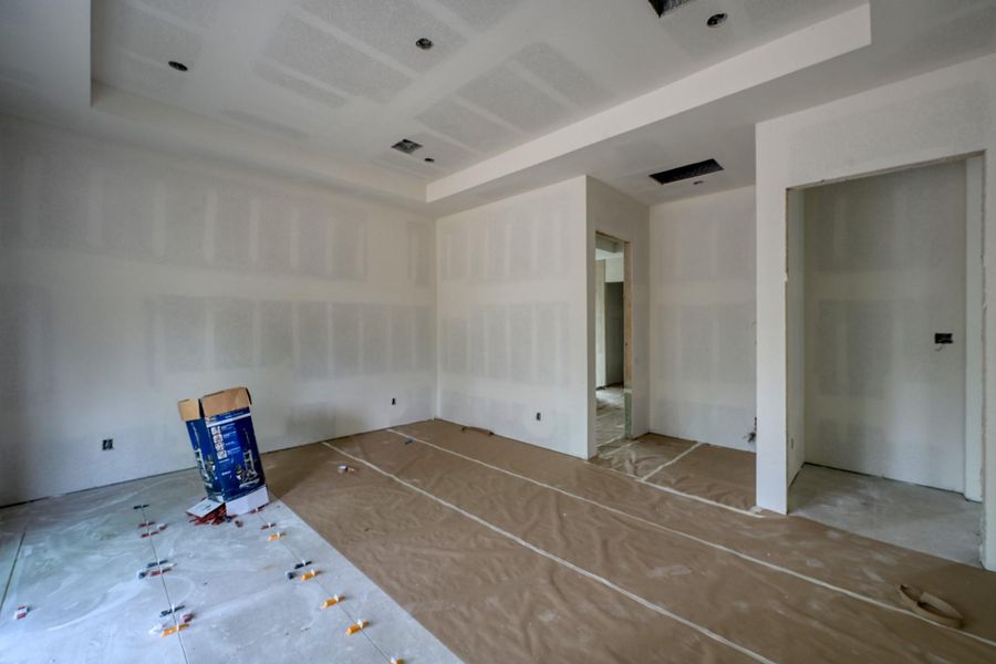 The primary suite is a tranquil haven featuring soft, earthy tones, tranquil views, and a private coffee bar with accent lighting—creating a perfect space for slow mornings and relaxing evenings.