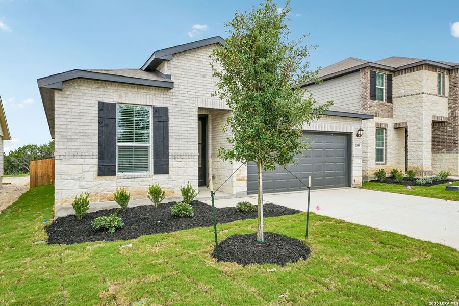 Front exterior of a new home in Thomas Pond, San Antonio, TX, highlighting curb appeal (Image 22).
