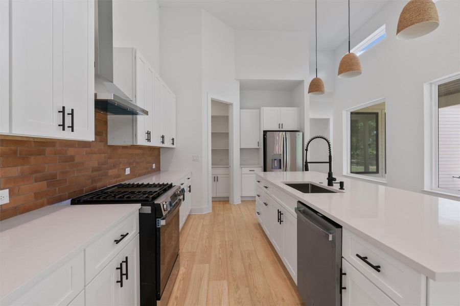 Culinary adventures await in this naturally illuminated kitchen, featuring pristine countertops and ample storage.