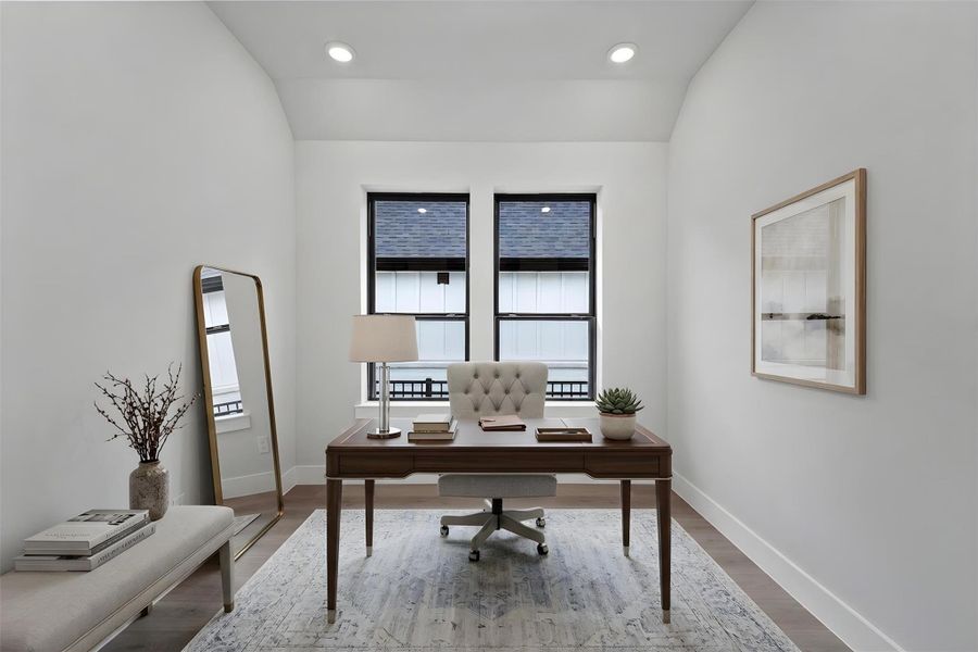 This handsome study/home office features laminate flooring, high sloped ceiling, recessed lighting, large windows, double doors, and custom paint! *Virtually Staged