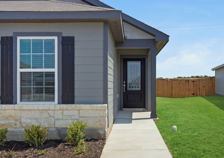 Single-story Medina floor plan front exterior featuring lap siding, a two-car garage, and landscaped front lawn. Single-story Medina floor plan front exterior featuring lap siding, a two-car garage, and landscaped front lawn.