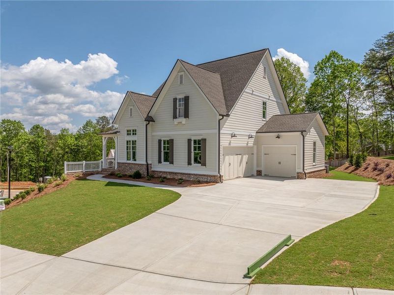 Front exterior of a new home in Malone's Pond, Ball Ground, GA, highlighting curb appeal (Image 2). Front exterior of a new home in Malone's Pond, Ball Ground, GA, highlighting curb appeal (Image 2).