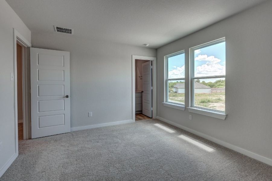 A room with white walls and a window.