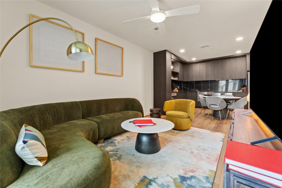 Clean lines and rich wood floors anchor this open-concept layout connecting relaxation to dining. Clean lines and rich wood floors anchor this open-concept layout connecting relaxation to dining.