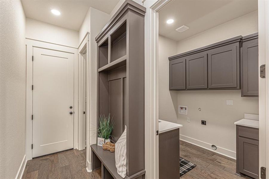 Laundry area featuring gas dryer hookup, dark wood finished floors, hookup for a washing machine, cabinet space, and recessed lighting
