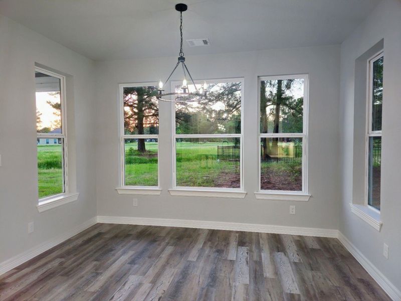 Dining room with large windows overlooking the golf course.