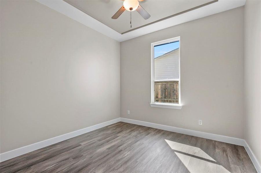 Unfurnished room featuring ceiling fan and wood-type flooring