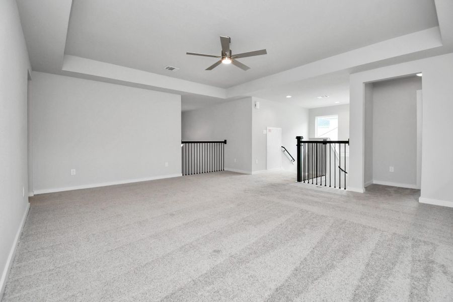 Come upstairs and enjoy a day of leisure in this fabulous game room! This is the perfect hangout spot or adult game room! Features plush carpet, high ceilings, custom paint and windows for plenty of natural light. Sample photo of completed home with similar floor plan. Actual colors and selections may vary. Come upstairs and enjoy a day of leisure in this fabulous game room! This is the perfect hangout spot or adult game room! Features plush carpet, high ceilings, custom paint and windows for plenty of natural light. Sample photo of completed home with similar floor plan. Actual colors and selections may vary.