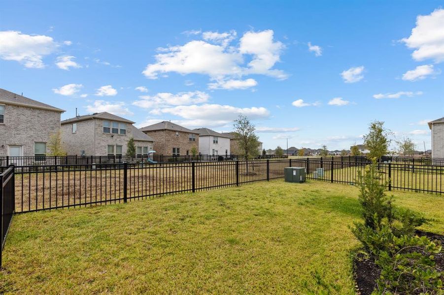 This lovely backyard is a peaceful setting and has plenty of space for a play set or outdoor kitchen area