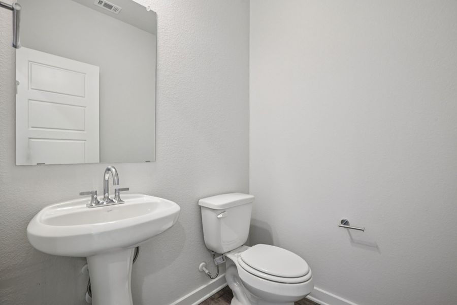 A bathroom with a toilet and sink.