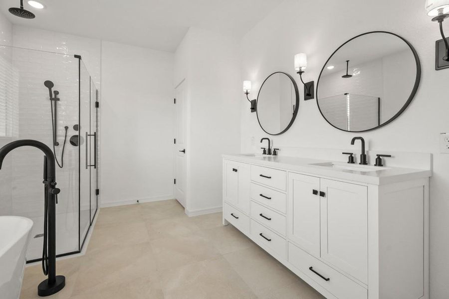 This posh primary bath has it all, including a spa-worthy primary tub, dual sinks, and a stylish barn door!
