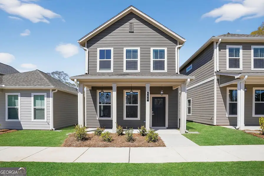Front exterior of a new home in The Cottages at East Lanier, Fayetteville, GA, highlighting curb appeal (Image 1). Front exterior of a new home in The Cottages at East Lanier, Fayetteville, GA, highlighting curb appeal (Image 1).