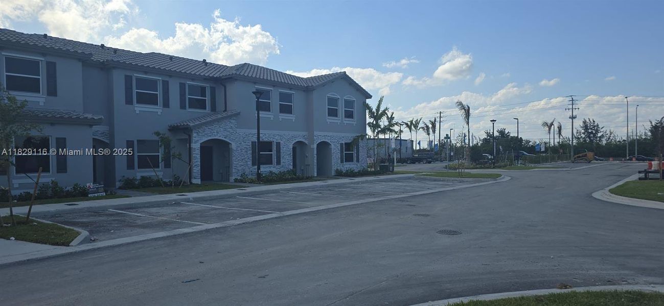 Front exterior of a new home in Le Jardine, Florida City, FL, highlighting curb appeal (Image 17).