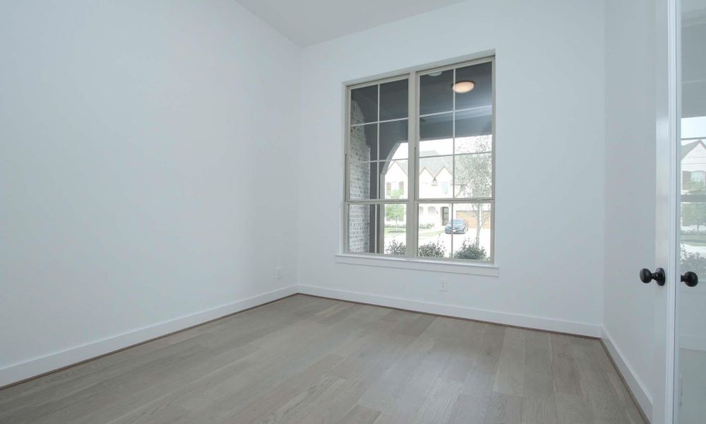 Spare room with light wood-style floors and baseboards