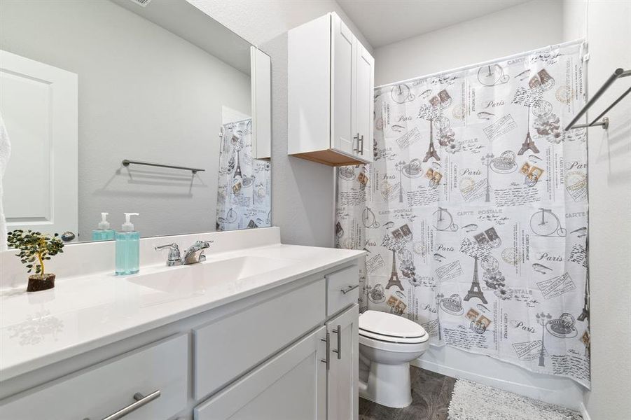 Full bathroom featuring vanity and shower / bath combo with shower curtain