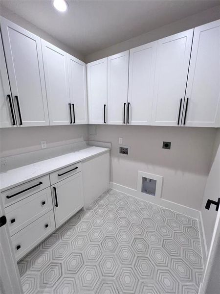 Nice laundry area with countertop space and abundant storage