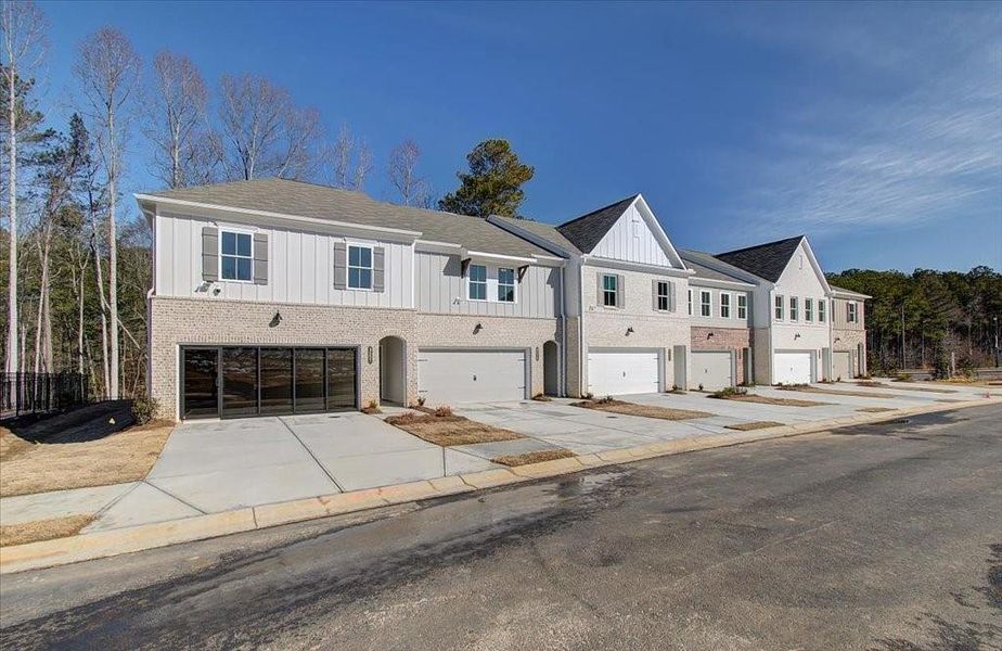 Front exterior of a new home in Wildwood Place, Powder Springs, GA, highlighting curb appeal (Image 1).