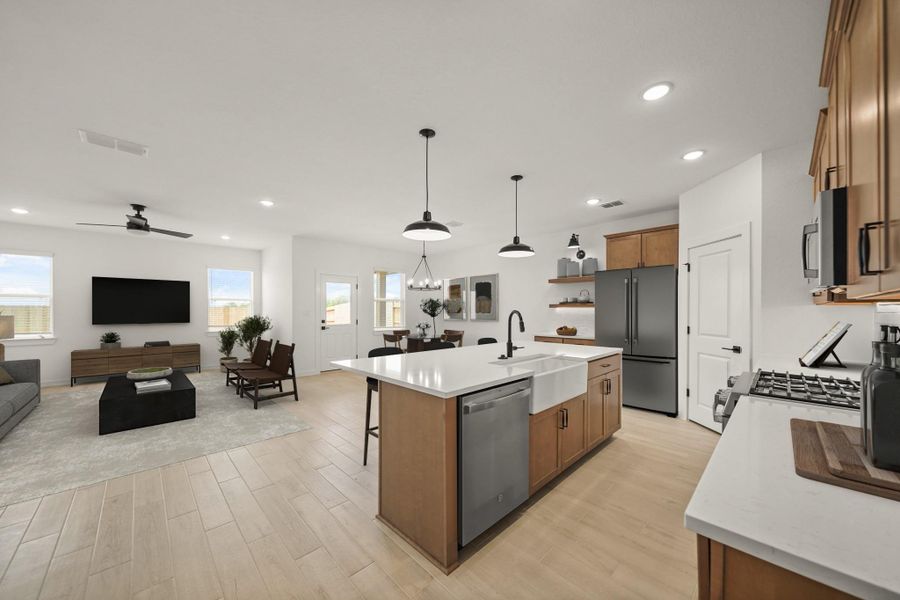 Kitchen open to the great room and dining area (*Photo not of actual home and used for illustration purposes only.)