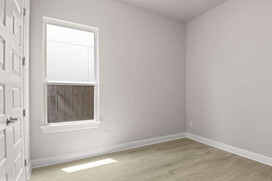 View of third bedroom with window in left corner