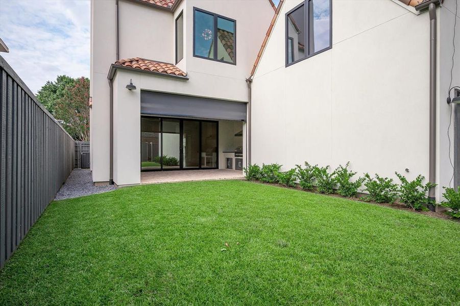 Back of property with a yard and a patio