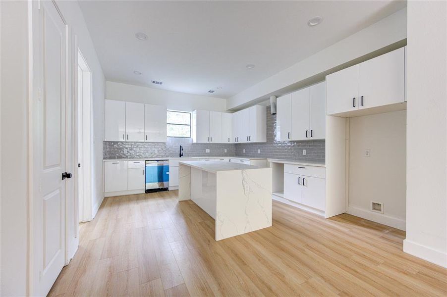 Large kitchen with lots of cabinets and counter space.