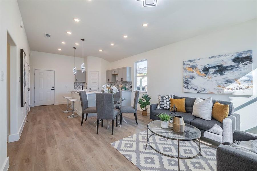 Living room featuring sink and light hardwood / wood-style flooring