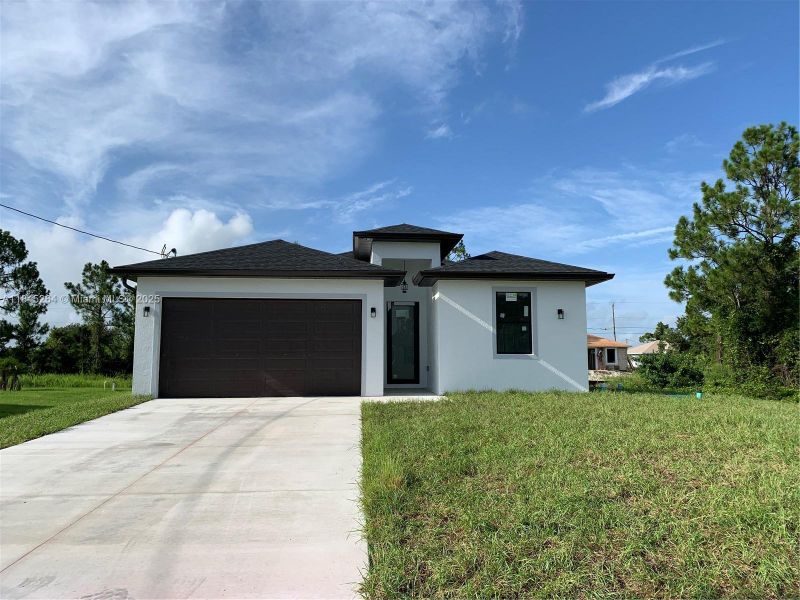 Front exterior of a new home in , Lehigh Acres, FL, highlighting curb appeal (Image 18).