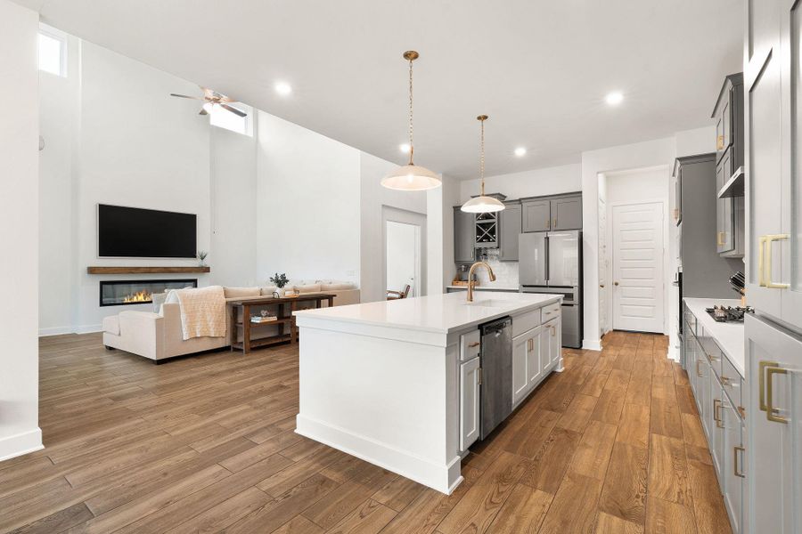 An open concept design seamlessly connects the kitchen and living room, bathed in natural light.