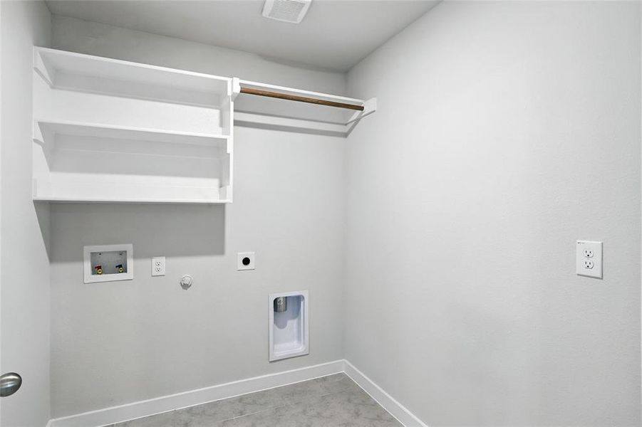 Laundry area with gas dryer hookup, hookup for an electric dryer, and washer hookup