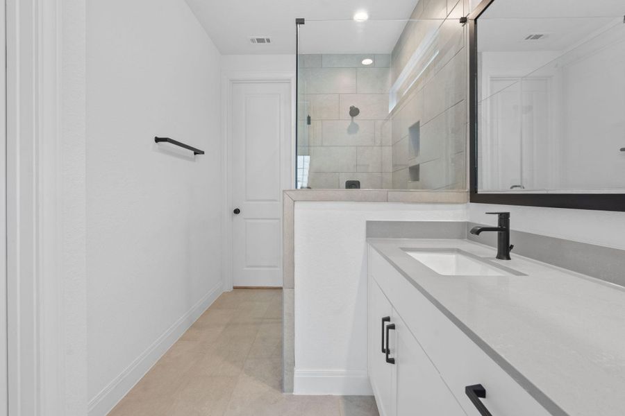Full bath with vanity, a walk in shower, and light tile patterned flooring Full bath with vanity, a walk in shower, and light tile patterned flooring