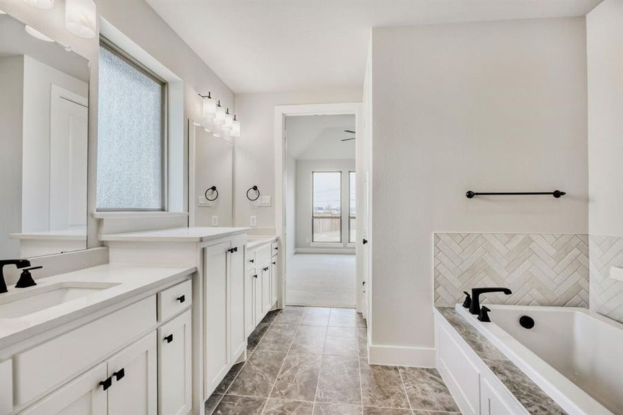 Bathroom with a bath and vanity