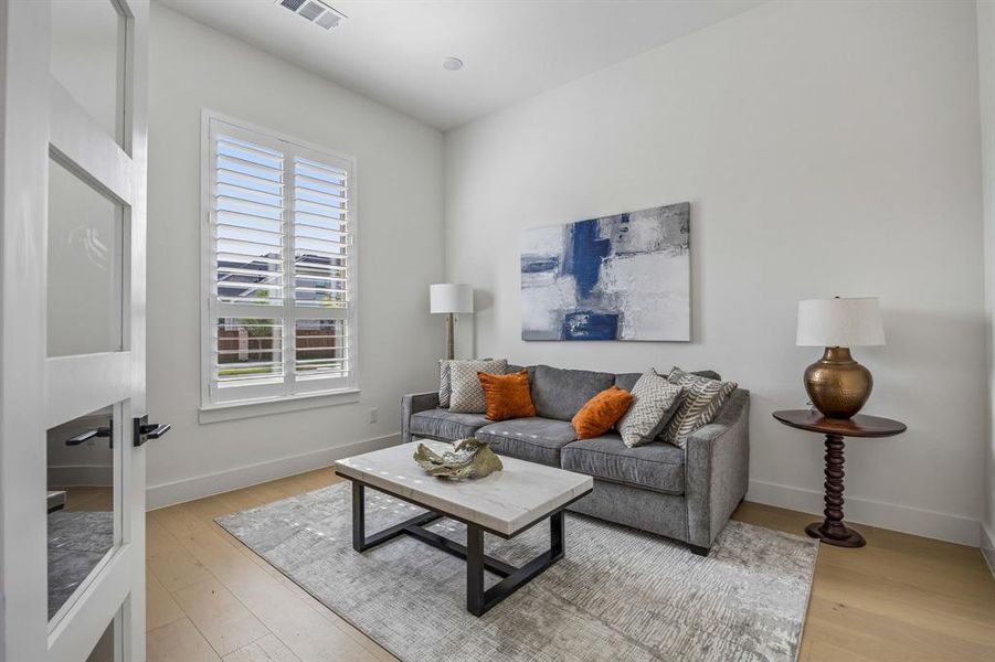 Living area featuring light wood finished floors and baseboards