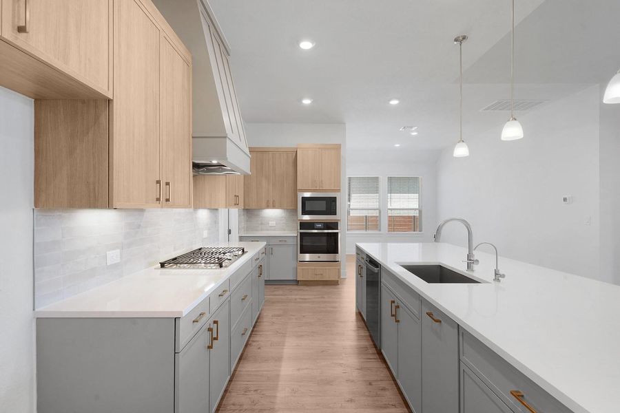 Culinary excellence awaits in this modern kitchen, boasting abundant counter space and integrated stainless steel appliances.
