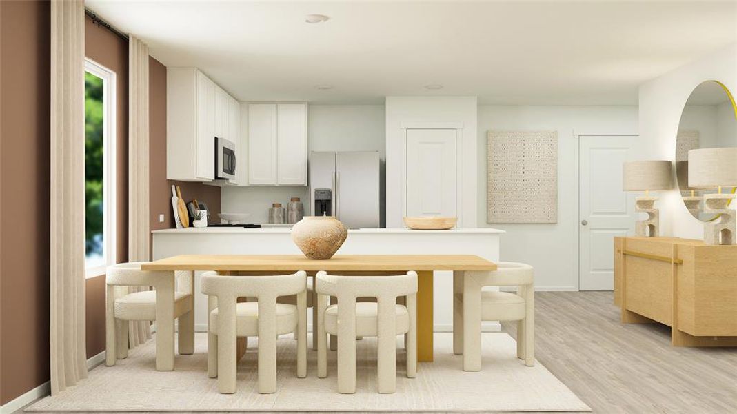 Kitchen featuring white cabinetry, light wood-type flooring, and fridge with ice dispenser