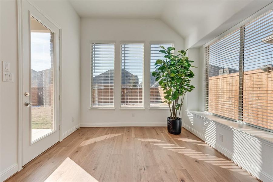 Unfurnished sunroom with vaulted ceiling and plenty of natural light