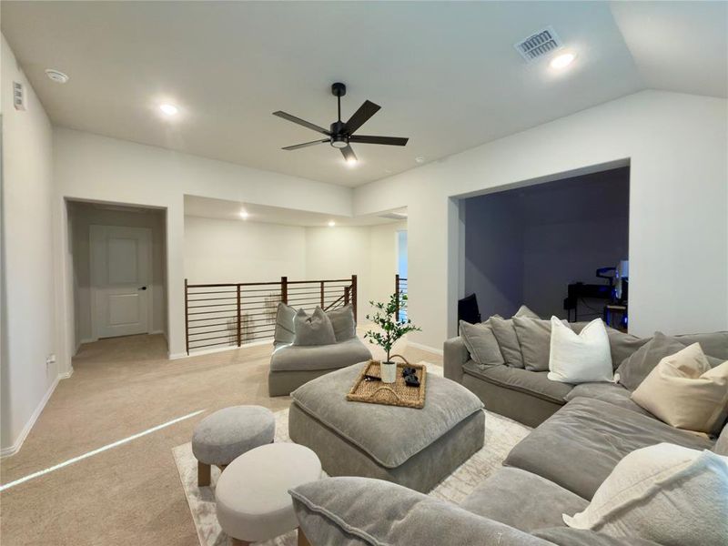 Living room with carpet flooring, a ceiling fan, and recessed lighting