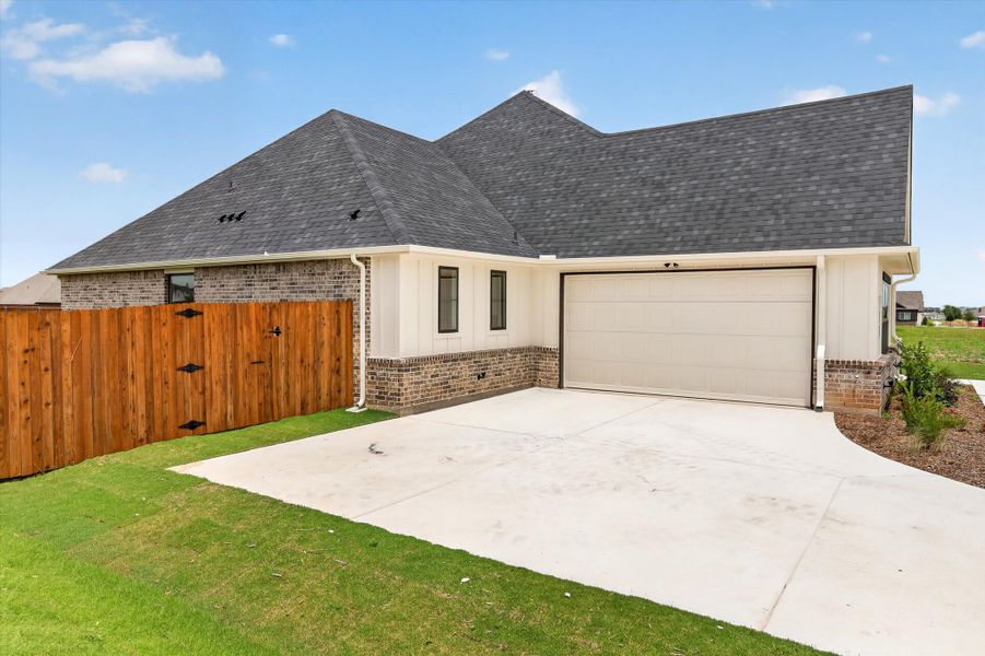 Front exterior of a new home in Coyote Crossing, Godley, TX, highlighting curb appeal (Image 25).