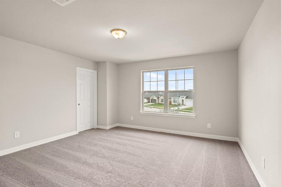 Your secondary bedroom features plush carpet, fresh paint, closet, and a large window that lets in plenty of natural lighting.