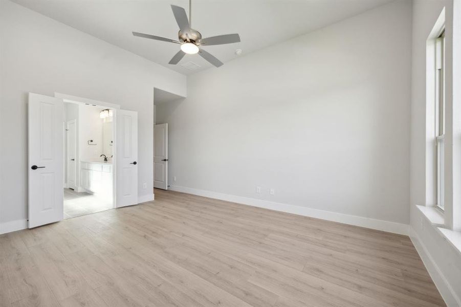 Unfurnished bedroom featuring ceiling fan and light hardwood / wood-style flooring