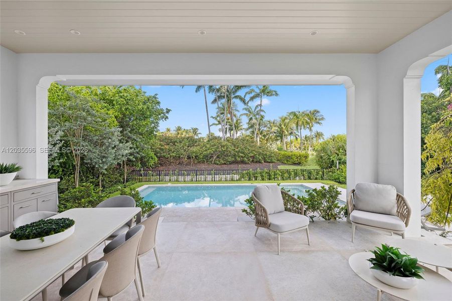 Outside living room with kitchen overlooks pool Outside living room with kitchen overlooks pool