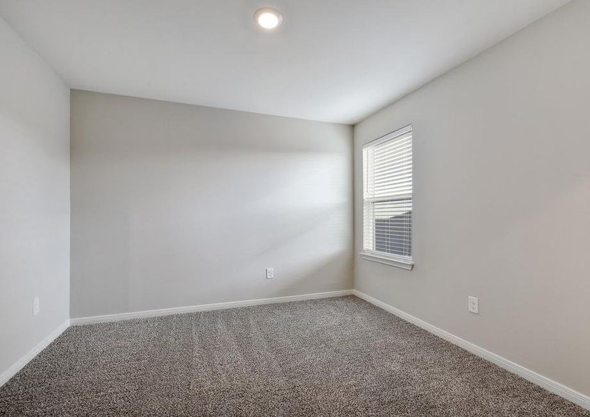 Secondary bedroom with a window and recessed lighting.