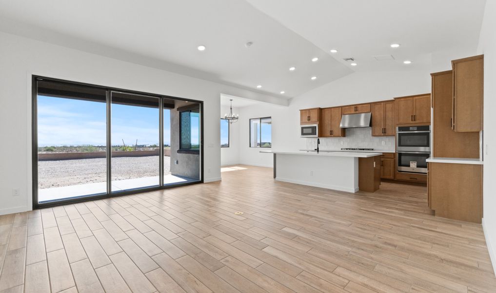Great room & kitchen united under soaring vaulted ceiling Great room & kitchen united under soaring vaulted ceiling